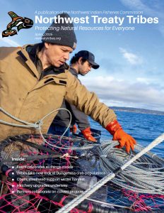 two fishermen prepare to deploy a crab pot into Puget Sound